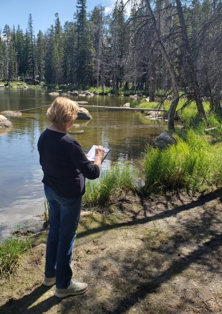 Image of Barbara Schaffner sketching near a lake